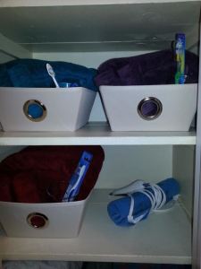 The girlfriend closet, a week after I created it.  One of my partners has already left a few more items at my house, accidentally. I've put them in her basket, so she can decide what to do with them the next time she visits. The heating pad is for "those days.")